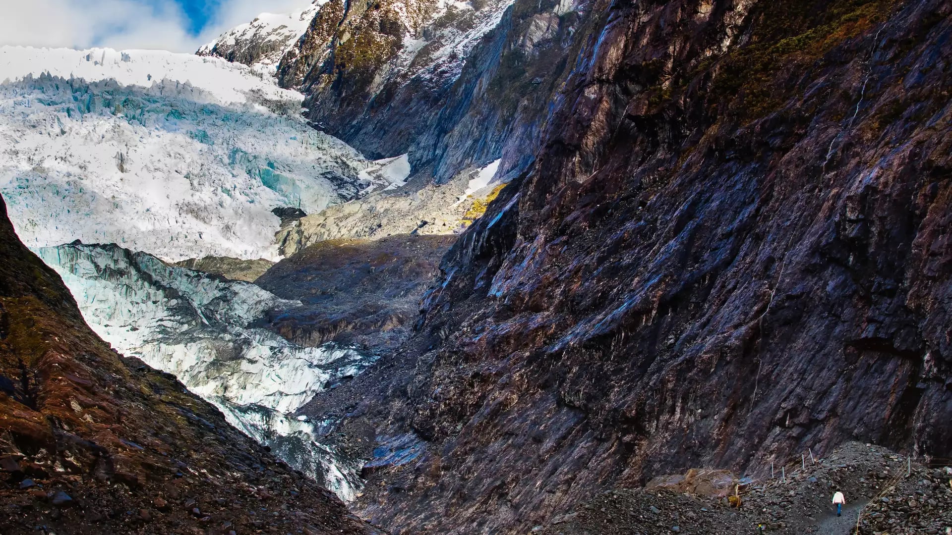 Aerial view of Franz Josef Glacier with mountains and clouds in New Zealand