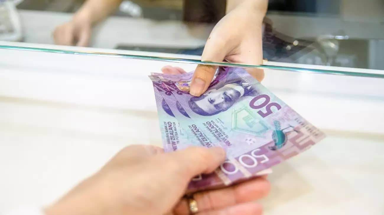 Photo of New Zealand money being handed over